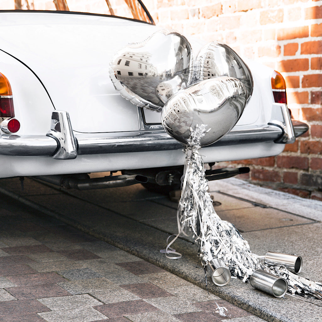 Wedding day car decoration kit with silver heart foil balloons, tassels and cans to decorate the back of the wedding car 