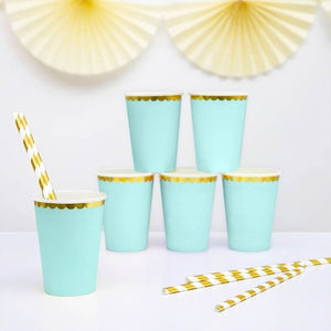 Mint green paper party cups with scalloped gold foil detail.