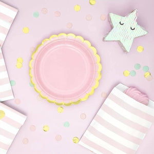 Pastel pink paper party plate with scalloped gold edge.