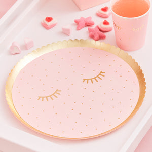 Pink pamper party with gold eyelash design party plates.