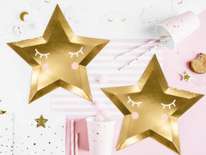 Gold star party plates with pink party cups with gold flecks and white straws with gold details. Perfect for Christmas and New Years celebrations.