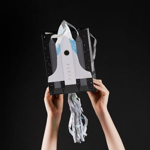 Black white and silver space paper party bags with rocket design and hanging silver tassel
