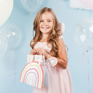 Image of girl with rainbow party bag & rainbow wand. 