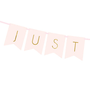 Gold foil words just married on pink blush card banner with matching pink ribbon