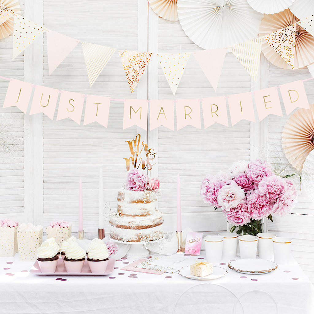 Pink and gold wedding banner with the words written just married