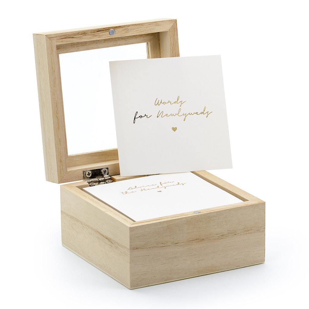 Wedding advice cards in white with gold foil words for newlyweds in a natural wooden box with a clear glass lid
