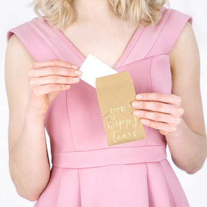 Wedding tissues with the words written in gold foil your happy tears on a kraft paper pack